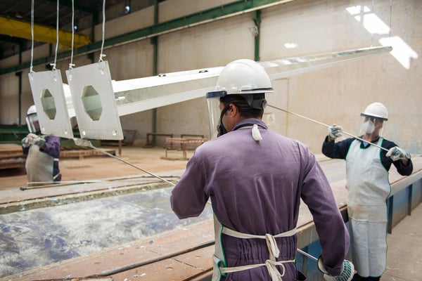 workers lifting metal