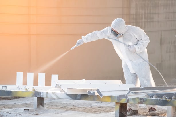 Worker Using Airless Sprayer